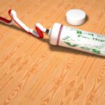 Dentifricio applicato su un graffio di legno, dimostrando il metodo per rimuoverlo facilmente.