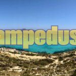 Caletta nascosta a Lampedusa con acque cristalline e scogliere selvagge, lontana dai sentieri turistici.